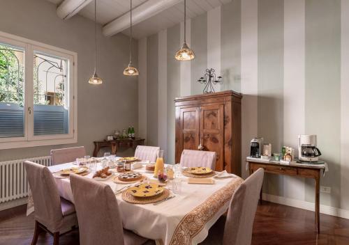 a dining room with a table and chairs and lights at B&B Arianna in Ravenna
