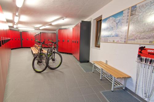 a bike parked in a room with red cabinets at SPA & Naturhotel Outside in Matrei in Osttirol