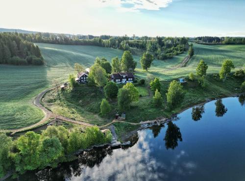 an aerial view of a house on an island in the water at WonderInn Riverside in Årnes