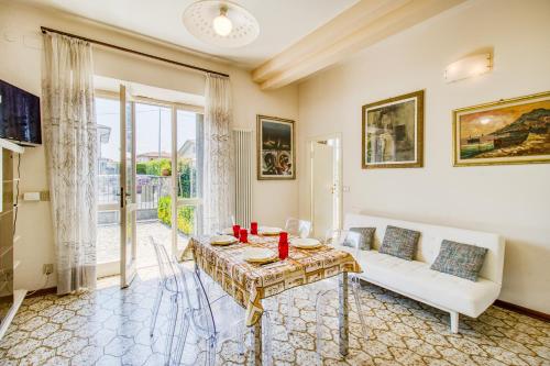 a living room with a couch and a table at Casa Lidia 900m From Sea - Happy Rentals in Lido di Camaiore