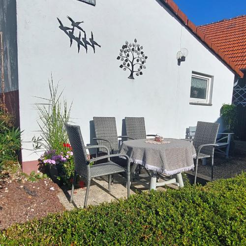 a patio with a table and chairs in front of a building at Bergfeldhof in Haingrund