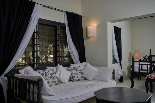 a living room with a white couch and a window at Saffron Garden Malindi in Malindi