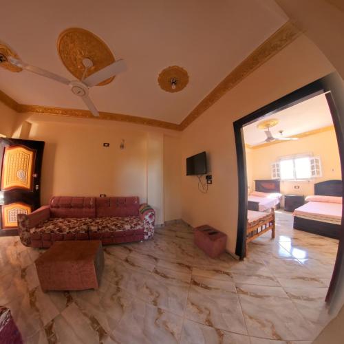 a living room with a couch and a mirror at Siwa star in Siwa