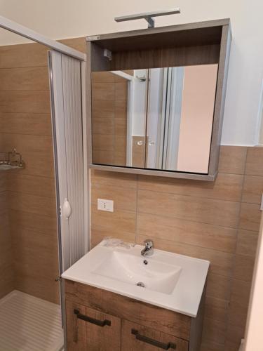 a bathroom with a sink and a mirror at La Foggia seaside paradise in Siculiana