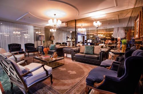 a large room with couches and chairs in a store at Sofistic Hotel in Itapema