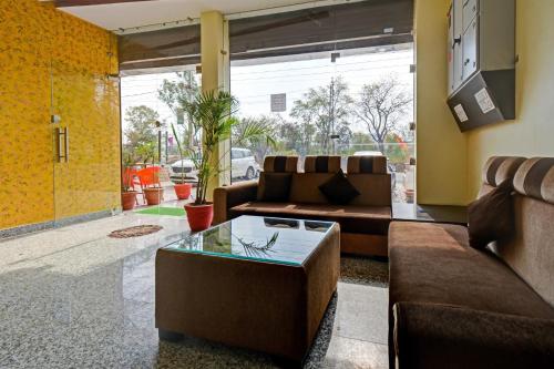 a living room with two couches and a coffee table at Capital O Maharana Palace in Udaipur