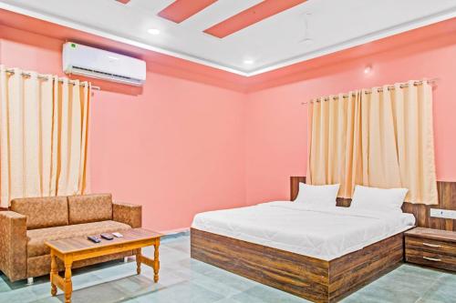 a bedroom with a bed and a chair at Flagship Hotel Patil 2 in Nagpur