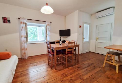 a living room with a table and chairs and a television at Apartment Gina in Bale