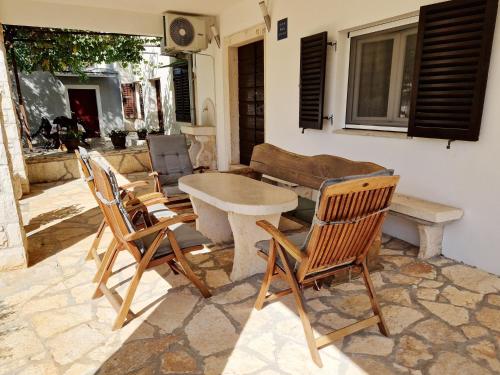 a patio with a table and four chairs at Apartment Gina in Bale