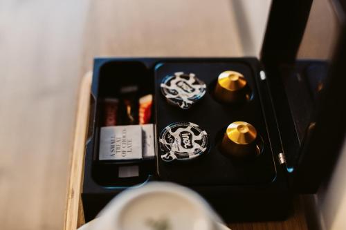 a black box with stickers on a table at Auberge du Pêcheur in Sint-Martens-Latem