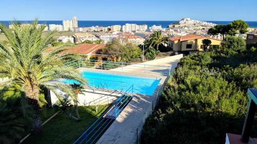 a swimming pool with a view of a city at Blu Mare apartment in Peniscola