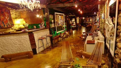 an overhead view of a living room with tables and chairs at Pousada Arte Urquijo in Paraty