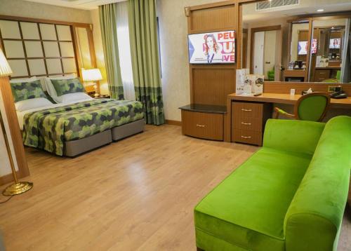 a hotel room with a bed and a couch at UNITED HOTEL INTERNATIONAL in Yaoundé