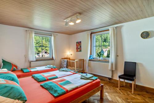 エンツクレスターレにあるSchwarzwaldhaus Zwinkのベッドルーム1室(ベッド2台、窓2つ付)