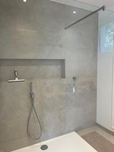 a bathroom with a shower with a shower head at Nouvelle construction dans le village de Fays in Theux