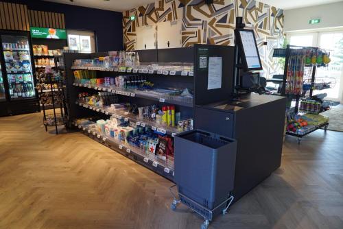 a store with a shelf with bottles of alcohol at EuroParcs Noordwijkse Duinen in Noordwijk aan Zee