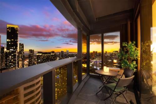 a balcony with a view of a city skyline at sunset at Fantastic Views at Luxury Prima Pearl Tower in Melbourne