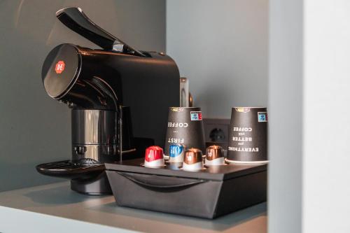 a coffee maker sitting on top of a counter at Van der Valk Hotel Düsseldorf in Düsseldorf
