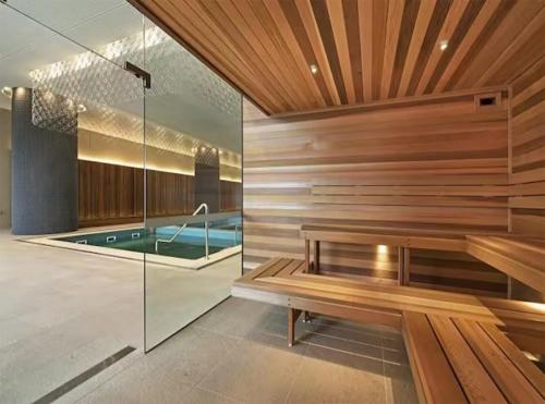a sauna with a bench and a swimming pool at Fantastic Views at Luxury Prima Pearl Tower in Melbourne