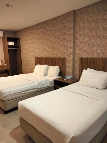 Ένα ή περισσότερα κρεβάτια σε δωμάτιο στο Hotel Jelai @ Raub, Pahang