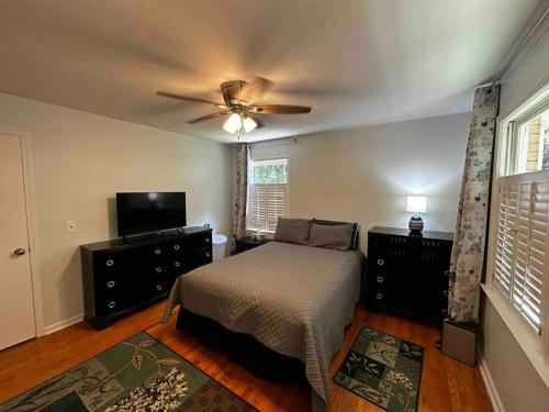 a bedroom with a bed and a ceiling fan at Babcia's Lake House in Columbia