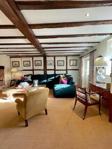 a living room with a couch and a table at Mimosa Cottage in Farnham