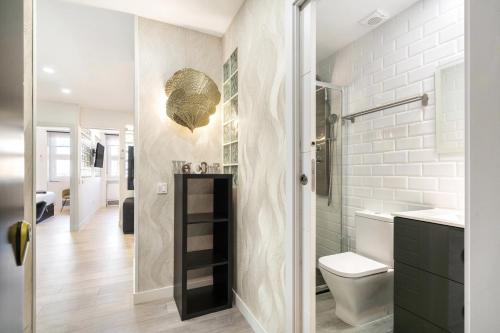 a bathroom with a shower and a toilet and a sink at Plaza España Apartment in Madrid