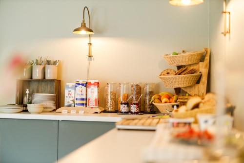 a kitchen with a counter with bread and baskets of food at Hotell Nyboholm in Ulricehamn