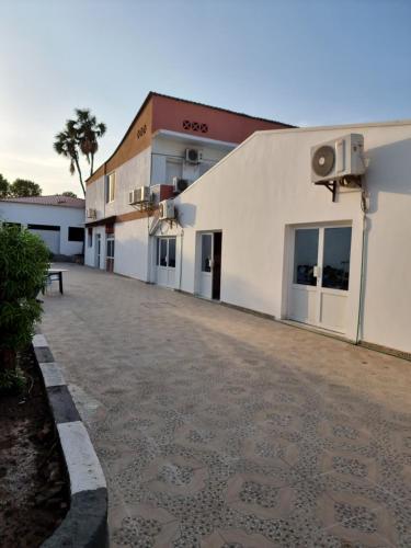 ein großes weißes Gebäude mit Parkplatz in der Unterkunft Hotel Rayan Djibouti in Dschibuti