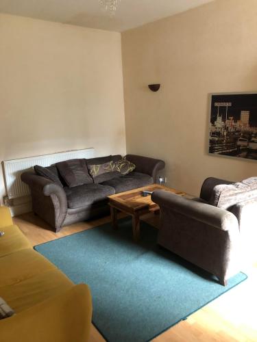 a living room with a couch and a coffee table at Room in town centre in Saint Helens