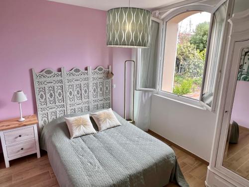 a bedroom with a bed and a window at Villa Gaudina in Bandol