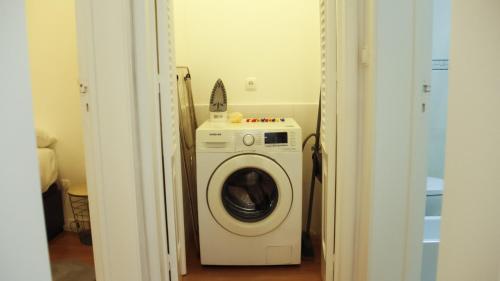 a white washer and dryer in a room at A m a r - 450m from the beach in São Roque
