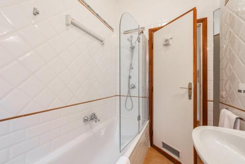 a bathroom with a shower and a tub and a sink at Studio Suite Aurelia Antica in Rome