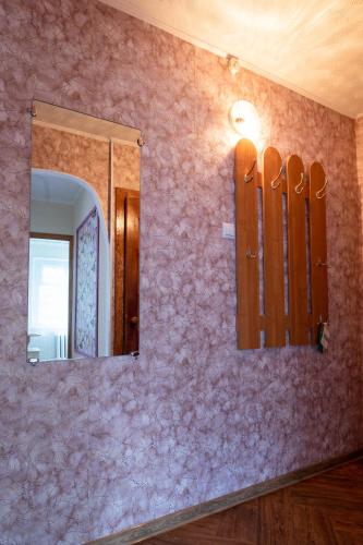 a bathroom with pink walls and a mirror at Дуглас in Petropavlovsk