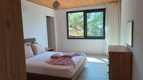 a bedroom with a bed with a dress on it at House of Joy in Marmaris