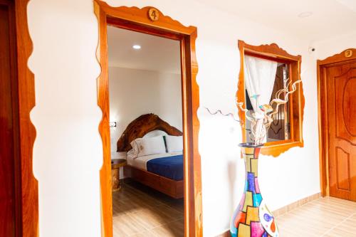 a mirror in a room with a bed and a bedroom at Hospedaje Vista Hermosa Salento in Salento