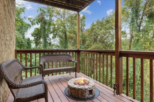 a porch with two chairs and a fire pit at Five-Bedroom House in Sevierville