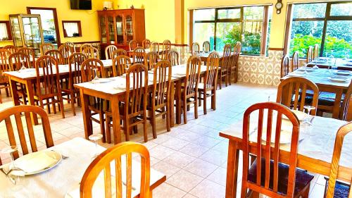 a dining room with tables and chairs in a restaurant at A Cista in Vila da Ponte