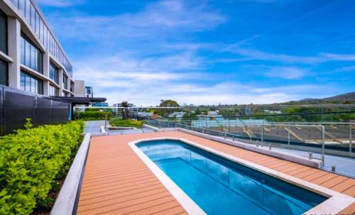 a swimming pool on the side of a building at Metropol 3 • Comfy• Luxury• Central • Free Parking in Canberra