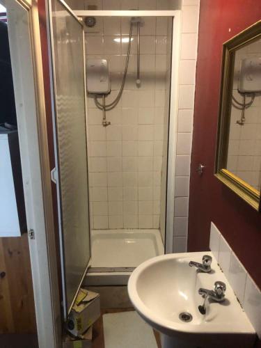 a bathroom with a sink and a shower at Room in town centre in Saint Helens