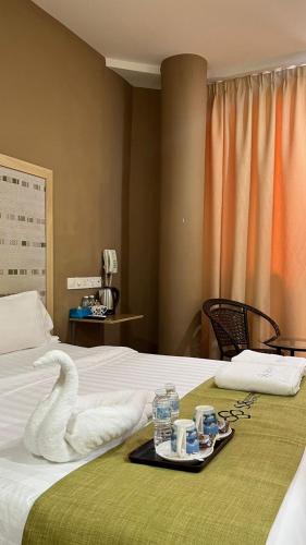 a hotel room with a swan tray on a bed at S8 Boutique Hotel near KLIA 1 & KLIA 2 in Sepang