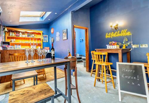 a restaurant with a bar with a table and chairs at Debenham Lodge Margate in Kent