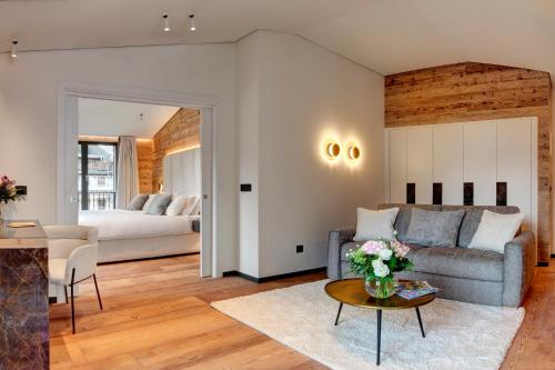 a living room with a couch and a table at Grand Hôtel des Alpes in Chamonix-Mont-Blanc