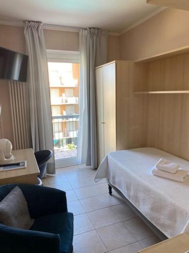 Llit o llits en una habitació de Hotel La Perla