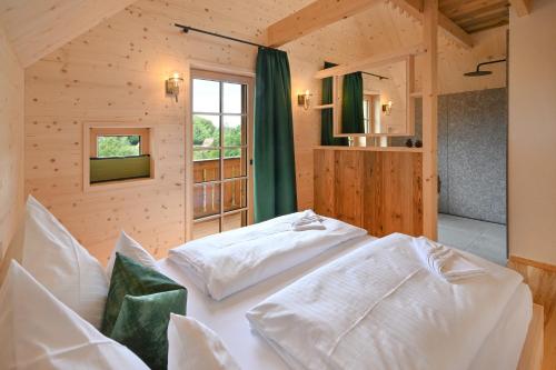 a bedroom with two white beds in a room at Oma Ludwin in Sasbachwalden