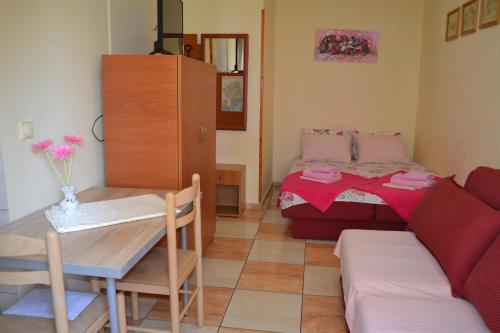 a small room with a bed and a table and a couch at Apartments Milosevic in Bar
