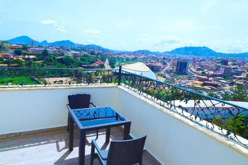 a table and chairs on a balcony with a view at UNITED HOTEL INTERNATIONAL in Yaoundé