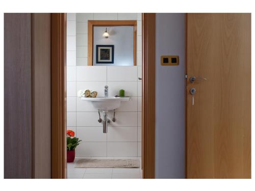 a bathroom with a sink and a mirror at Apartments Moderno 2 in Fažana