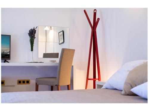 a bedroom with a bed and a table and a chair at Apartments Moderno 2 in Fažana