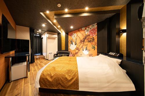 une chambre d'hôtel avec un lit et un tableau sur le mur dans l'établissement Hotel　このへんのアジア, à Kyoto